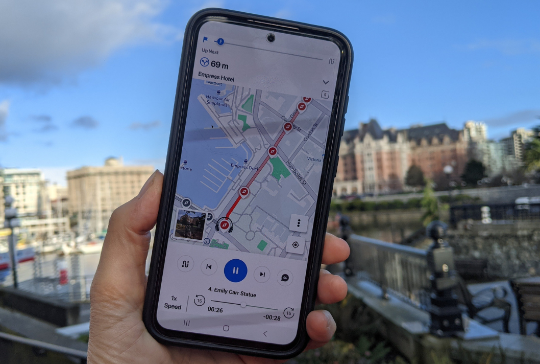 a cell phone with a map of victoria being held by a hand